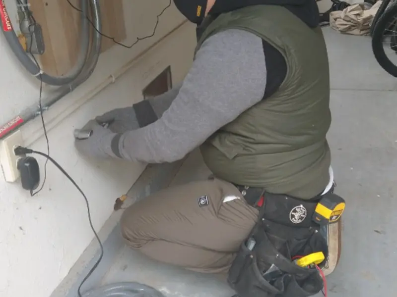 Electrician performing outlet wiring in a Edgewood garage
